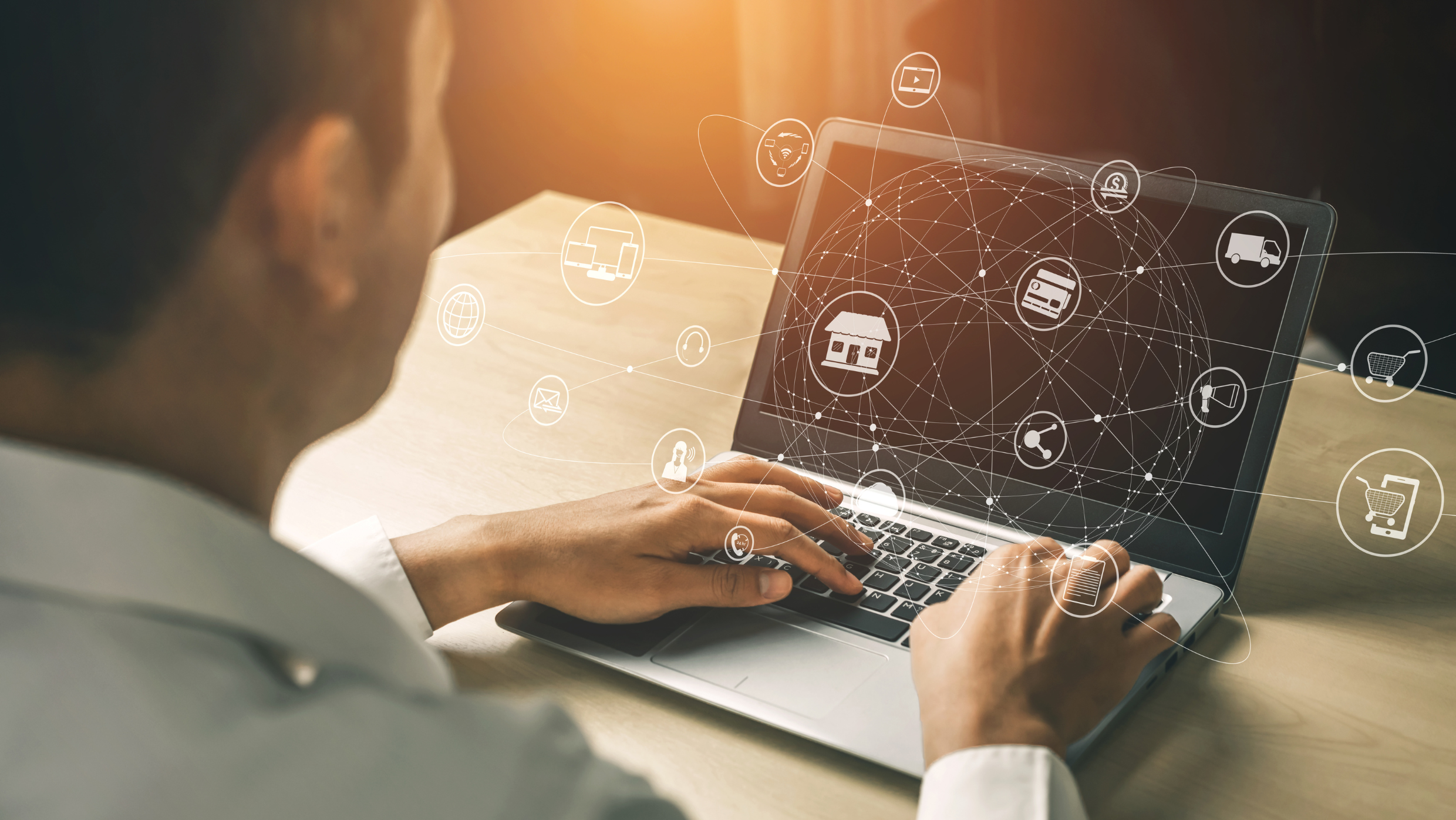 Man sitting infront of laptop that portrays an omnichannel approach to communication.